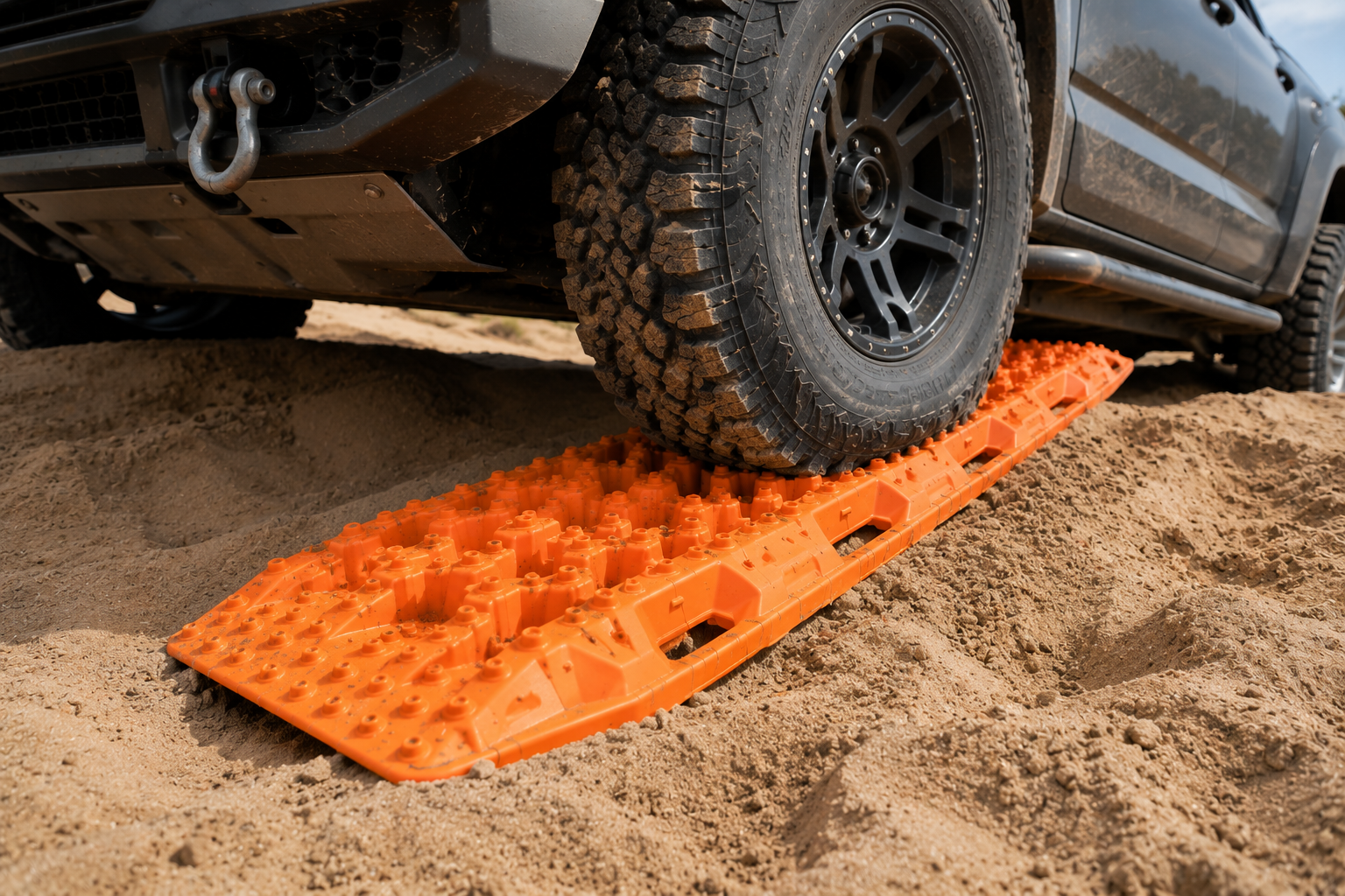 Vehicle tyre gripping the raised teeth of a recovery board