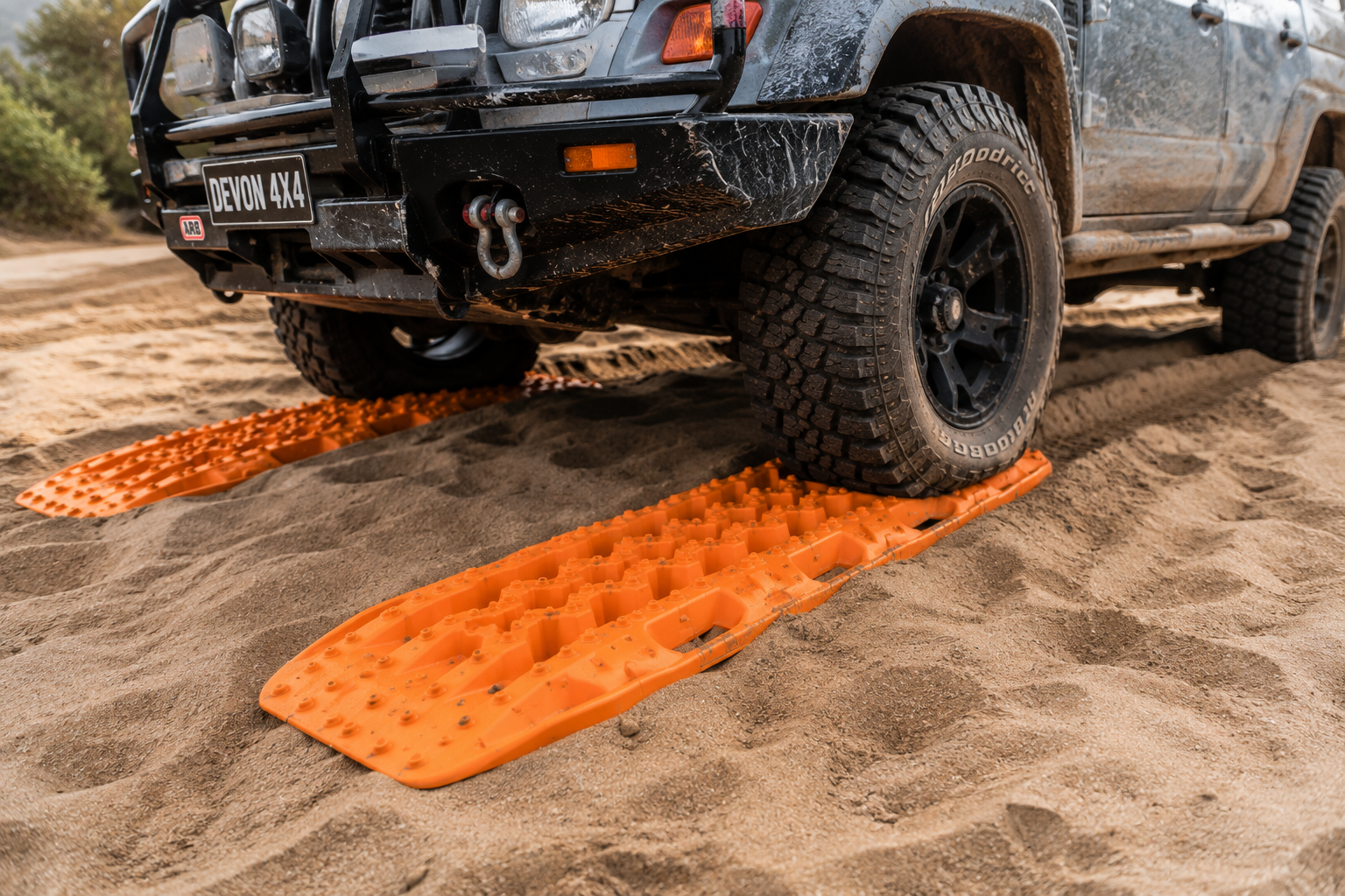 Pair of off-road recovery boards beside a four-wheel-drive vehicle